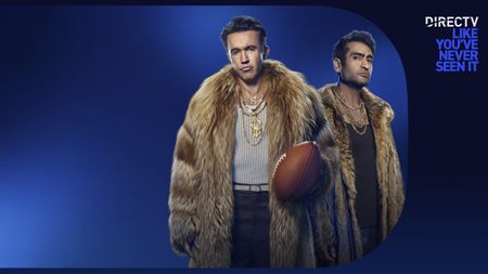 Kumail Nanjiani and Rob McElhenney pose on a DIRECTV promo poster that reads "DIRECTV like you've never seen it"